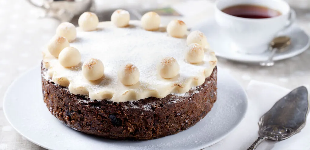 Traditional English Easter cake with marzipan decoration on a white plate